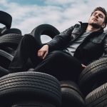 Man lying on a giant pile of tires